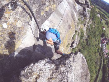 Man standing on cliff against mountain