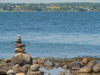 Stack of rocks on beach against sky