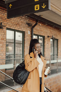 Young woman waiting at bus station