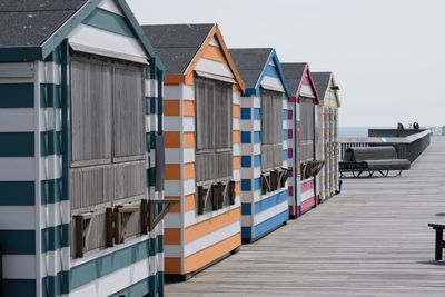 Row of houses on pier against sky