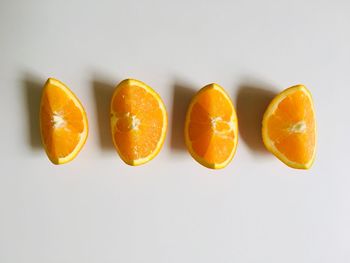 Close-up of orange fruit against white background