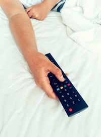 High angle view of person with remote control