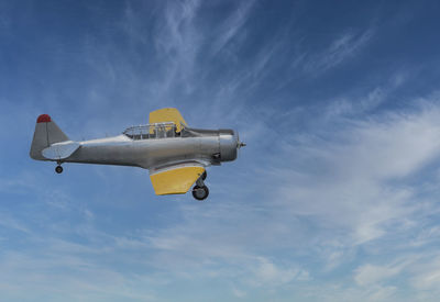 Low angle view of airplane flying against sky