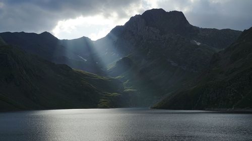 Scenic view of lake and mountains against sky