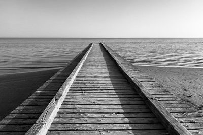 Pier over sea against clear sky