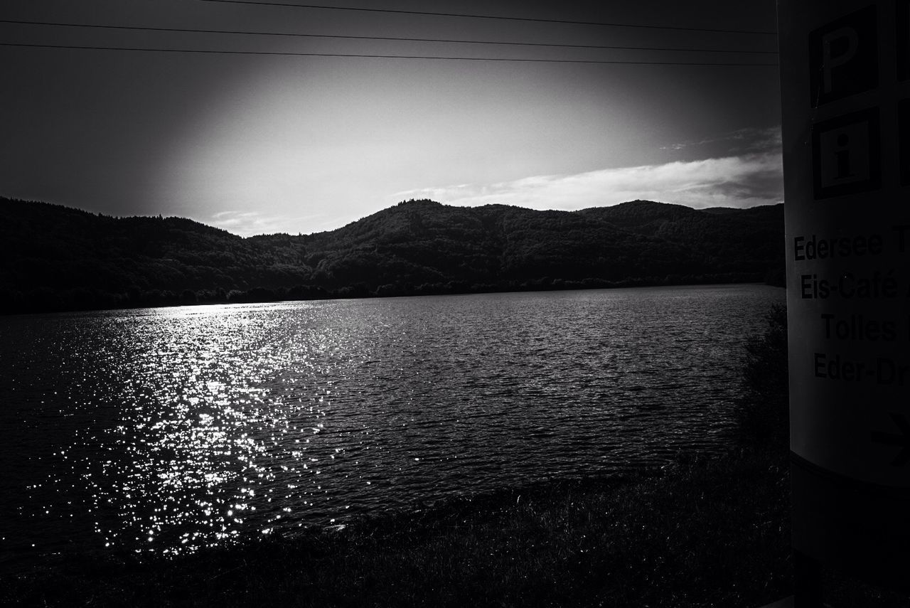 SCENIC VIEW OF LAKE AGAINST MOUNTAIN RANGE