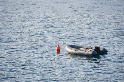 Rubber inflatable boat moored in adriatic sea water