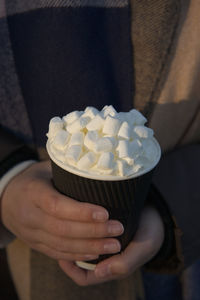 Midsection of person holding ice cream