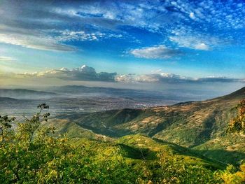 Scenic view of landscape against cloudy sky