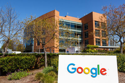 Text on building against clear blue sky