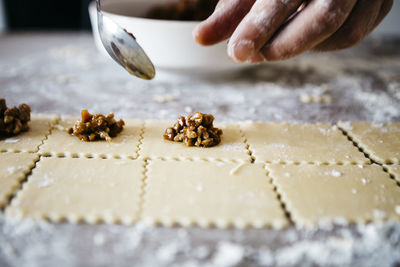 Cropped hands of male chef preparing food on table