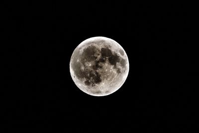 Low angle view of moon against clear sky at night