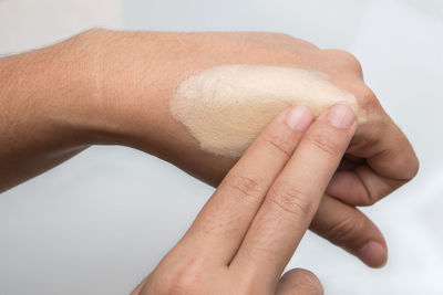 Close-up of hands over white background