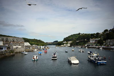 Boats moored on river against sky