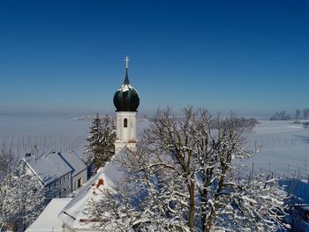 Snow covered building against sky