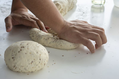 Man kneading a large dough for homemade bread in quarantine