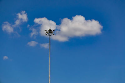 Low angle view of floodlight against blue sky