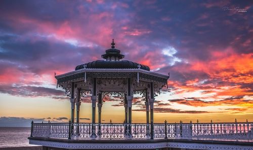 Traditional building against cloudy sky during sunset