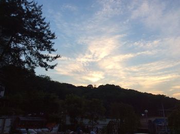 Scenic view of mountains against cloudy sky