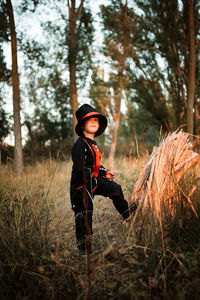 Portrait of boy wearing costume during halloween standing at forest