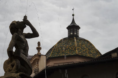 Low angle view of statue against cloudy sky