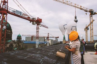 Man working at construction site against sky