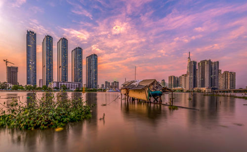 View of modern buildings against sky during sunset