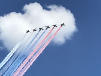 Low angle view of airshow against sky