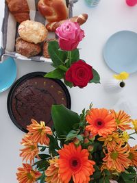 High angle view of multi colored roses in vase on table