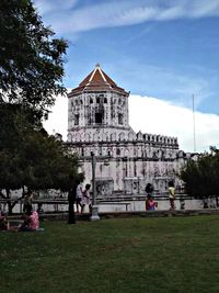 Facade of building against cloudy sky