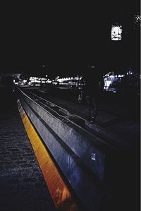 Man walking on railroad station platform at night