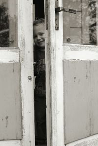 Close-up of a woman against blurred built structure