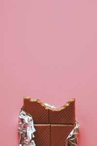 Close-up view of chocolate over pink background