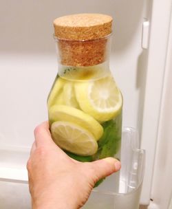 Close-up of hand holding glass of juice