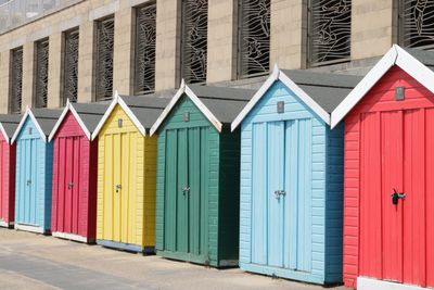 Multi colored huts on beach by building