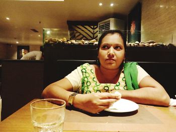 Portrait of woman sitting at restaurant table