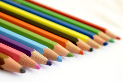 Close-up of colorful pencils on white background