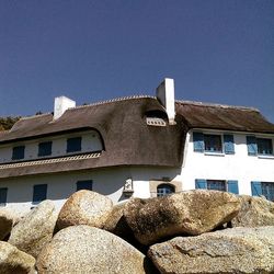 Low angle view of building against clear blue sky