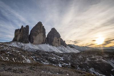 Scenic view of rocky mountains against sky during sunset