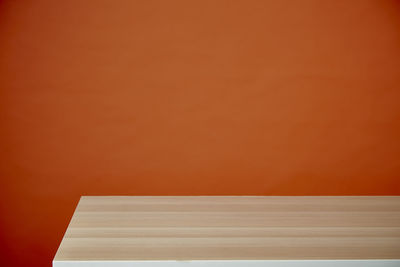 Close-up of empty table against wall