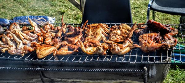 High angle view of chicken wings on barbeque