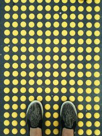 Low section of woman standing on tiled floor