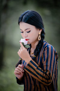 Portrait of young woman blowing bubbles