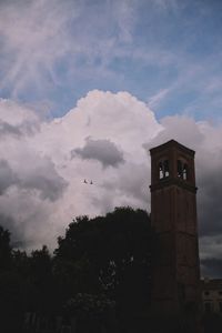 Low angle view of building and trees against sky