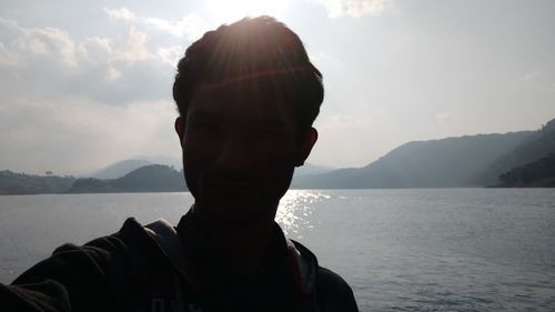 Portrait of man in mountains against sky