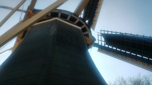 Low angle view of communications tower against sky