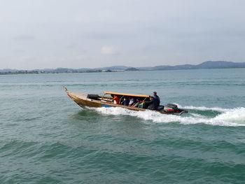 Boat sailing in sea against sky