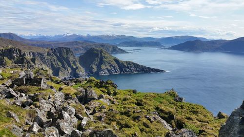 Scenic view of sea and mountains against sky