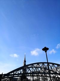 Low angle view of bridge against blue sky