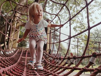 Toddler on walkthrough rope climbing frame